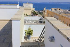 a balcony with a view of the ocean at Palazzo Angelelli in Gallipoli