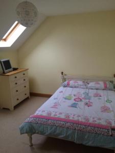a bedroom with a bed and a dresser at Portstewart - holiday let in Portstewart