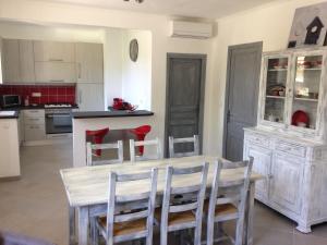 a kitchen with a table and chairs in a room at Le 43 in La Trinité