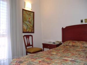 Ліжко або ліжка в номері Hotel Posada Arcos