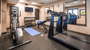 a gym with treadmills and elliptical machines at Ramada by Wyndham Burkburnett - Wichita Falls in Burkburnett