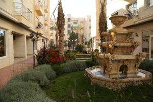 a fountain in the middle of a courtyard at Western Gate Residence 2 Amman in Amman