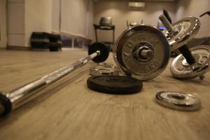 a barbell and other items on a wooden floor at Western Gate Residence 2 Amman in Amman