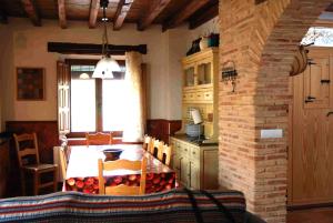 a kitchen with a table and a dining room at Casa del Rio in Villanueva de la Jara