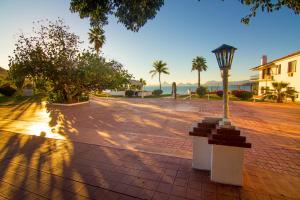 a street light on a brick sidewalk with palm trees at Hotel Playa de Cortes in Guaymas