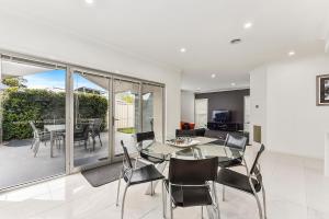 a dining room and living room with a table and chairs at Urban Corporate Apartment in Mount Gambier