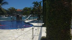 a swimming pool with a slide in a resort at Casa Angra Itanema in Angra dos Reis