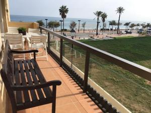 a balcony with benches and a view of a park at Apartment on the beach,fuengirola in Fuengirola