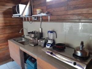 a kitchen with a counter top with a stove at Kakiang Homestay in Nusa Lembongan +8 photos