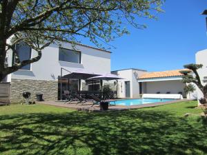 a house with a swimming pool and a yard at La Meilleraie in Les Sables-d'Olonne