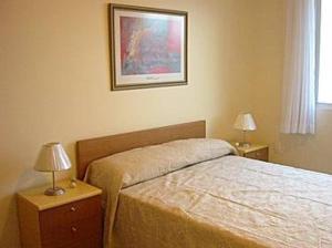 a bedroom with a bed and two night stands with lamps at Residencial Solar Bela Vista in Florianópolis