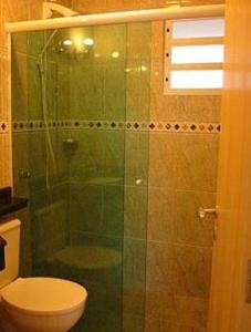 a bathroom with a glass shower with a toilet at Residencial Solar Bela Vista in Florianópolis