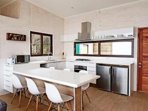 a kitchen with a white counter top and white appliances at Casa Las Puyas Top Hill Incredible View + Hot Tub in Navidad +30 photos