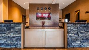 a lobby of a hotel with two stone walls at Best Western Plus Estevan Inn & Suites in Estevan