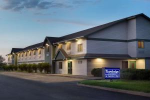 a house with a sign in front of it at Travelodge by Wyndham Alpine in Alpine