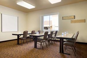 a conference room with tables and chairs and a window at Travelodge by Wyndham Gillette in Gillette