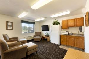 a living room with a refrigerator and a kitchen at Travelodge by Wyndham Yampa in Yampa