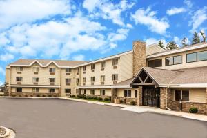 a building with a basketball court in front of a driveway at AmericInn by Wyndham Sheboygan in Sheboygan