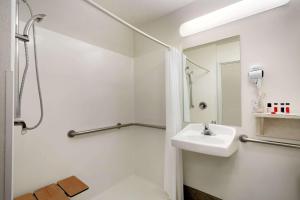 a white bathroom with a sink and a mirror at Travelodge by Wyndham Yampa in Yampa +15 photos