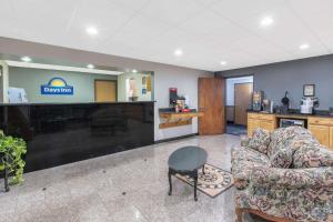 a waiting room with a couch and a table and a bar at Days Inn by Wyndham Hornell NY in Hornell