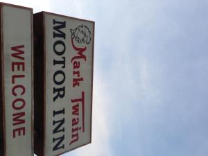 a sign for a restaurant on the side of a building at Mark Twain Motor Inn in Elmira