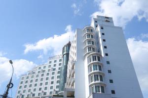 a tall white building with a sky in the background at Cat Linh ARL55 Hotel in Hanoi