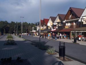 a street in a town with people walking down the street at Pokoje Nerja in Władysławowo