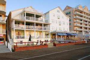 a building on a pier next to a boardwalk at Majestic Hotel & Apartments in Ocean City