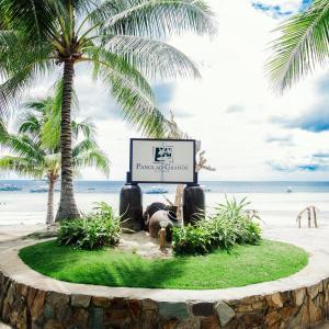 a sign on a beach with palm trees and the ocean at Panglao Grande Resort 邦劳美丽度假村 in Panglao