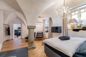 a bedroom with a large bed and a chandelier at Passau42 in Passau