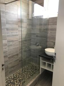 a bathroom with a glass shower and a sink at Modern rooms available close to the beach in Humewood in Port Elizabeth