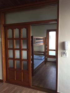 a small room with a bed and a door at Jeju Guesthouse in Jeju