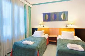 a hotel room with two beds and a window at Holiday Club Saariselkä in Saariselka +60 photos