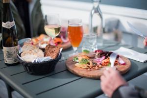 a table with two plates of food and glasses of wine at Hotel Icefiord in Ilulissat