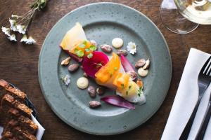 a plate of food with vegetables on a table at Hotel Icefiord in Ilulissat