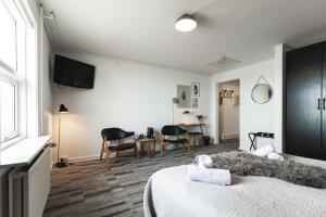 a bedroom with a bed and a table and chairs at Hotel Icefiord in Ilulissat