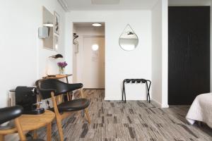 a room with a table and chairs and a hallway at Hotel Icefiord in Ilulissat