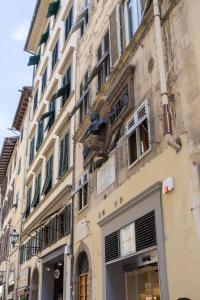 a building with a clock hanging from the side of it at Guesthouse Bel Duomo in Florence