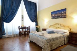 a hotel room with a bed and a table at Guesthouse Bel Duomo in Florence