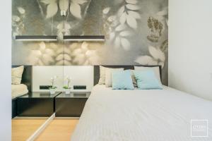 a bedroom with a large bed with blue pillows at Apartamenty Premium Wadowice in Wadowice