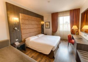 Uma cama ou camas num quarto em FH55 Grand Hotel Palatino