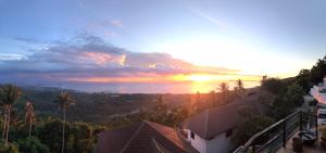 a sunset view of the ocean from a house at Samui Paradise Village in Nathon