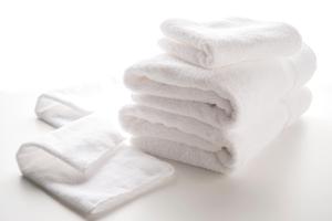 a stack of white towels on a white background at Hotel Villa Fontaine Tokyo-Hamamatsucho in Tokyo