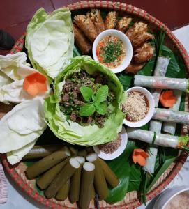 a plate of food with vegetables and other foods at Mai Châu Home in Mai Châu