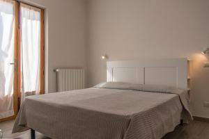A bed or beds in a room at Hotel Villa Rita