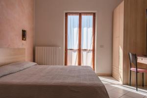 A bed or beds in a room at Hotel Villa Rita