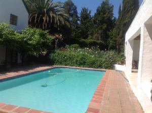 a swimming pool in the yard of a house at Willow Brooke Guest Suite in Franschhoek