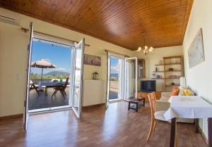 a living room with a table and a dining room at oli terra in Lefkada +42 photos