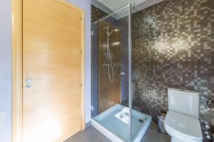 a bathroom with a shower and a toilet at Villa Alegria in L'Escala +18 photos