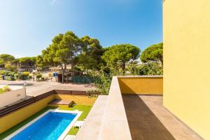 a swimming pool on the side of a building at Villa Alegria in L'Escala